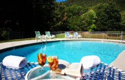 pool with chairs and towels at christopher place