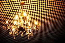 chandelier hanging on checkered ceiling