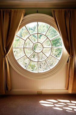 round window with curtains