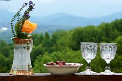 boquet of flowers, cherries in bowl and wine glasses