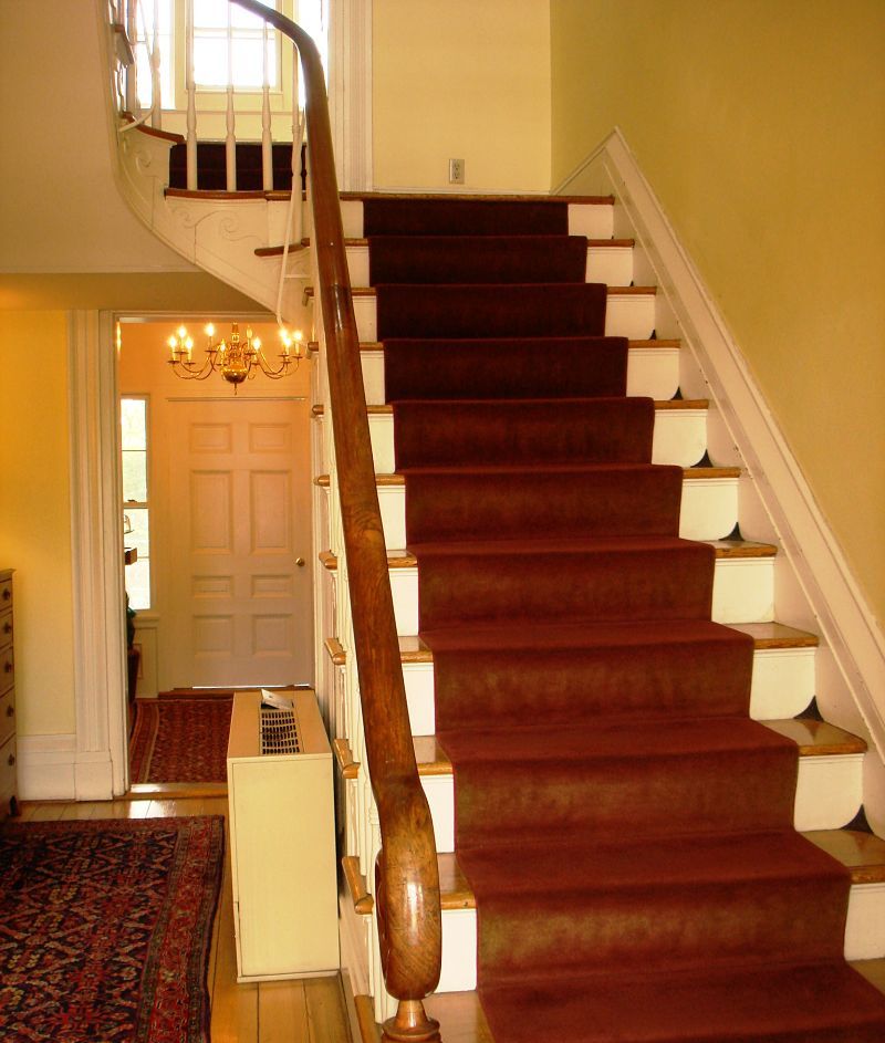 ornate staircase with red carpet
