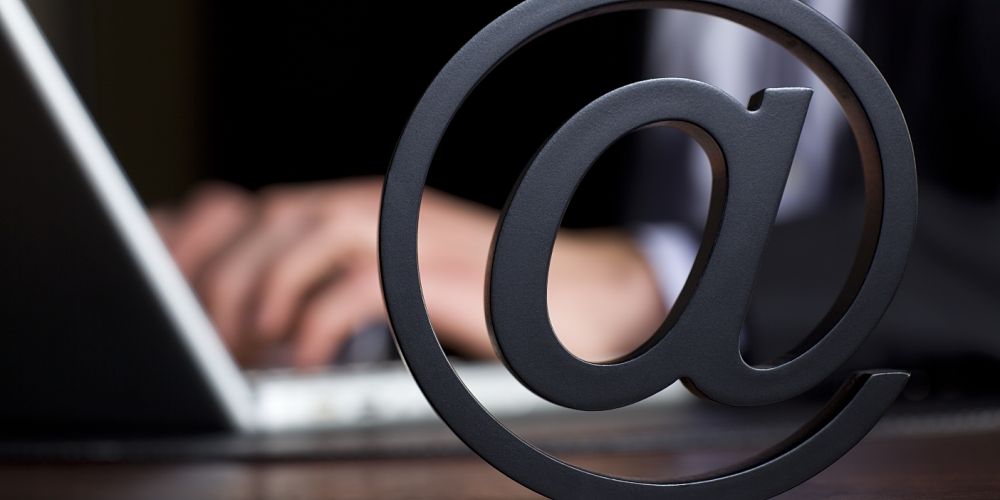 Man on Computer with Email Symbol