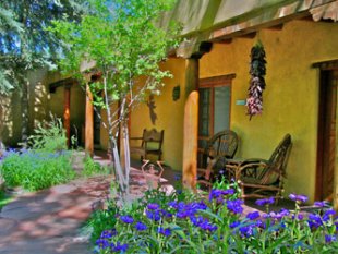 Hacienda del Sol summer gardens featuring Bachelor Buttons, Chili Ristras, and flagstone path