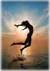 woman girl jumping out of the water with sun behind her