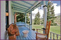 bonanza room deck patio with bench and chair facing rocky mountains