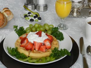 waffles with straberries, whiped cream and grapes