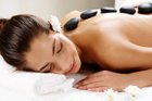 Girl with hot stones on back in spa