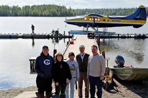 A happy grouo of Crooked Creek guests on their fly out in a float plane