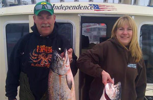 Two guests holding King Salmon from a Cook Inlet Combo trip