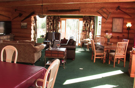 Log lodge with table, chairs, and couches