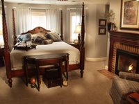 bed, end table and fireplace
