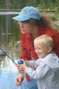 grandma and grandson fishing at lake in Beartooth Mountains