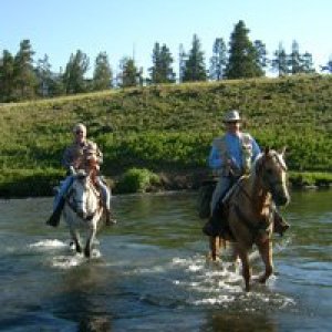 riding horseback across the Lamar river in yellowstone national park