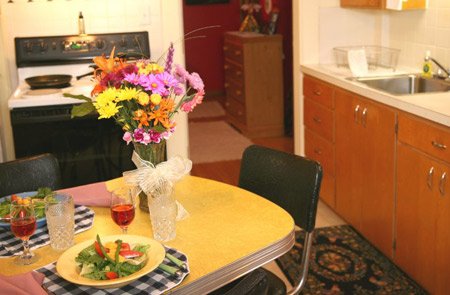 Dining table with floral centerpiece.