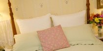 bed with flowers on nightstand
