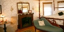 fireplace and bed of the Westby Room
