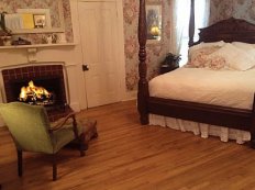 Bed with chair and fireplace