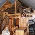 Living area with kitchen in Crazy Horse Cabin at Hochatown Junction in Broken Bow, OK