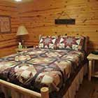 bed in Triple Oaks Cabin at Hochatown Junction in Broken Bow, OK