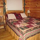 bed in Bear Necessities Cabin at Hochatown Junction in Broken Bow, OK