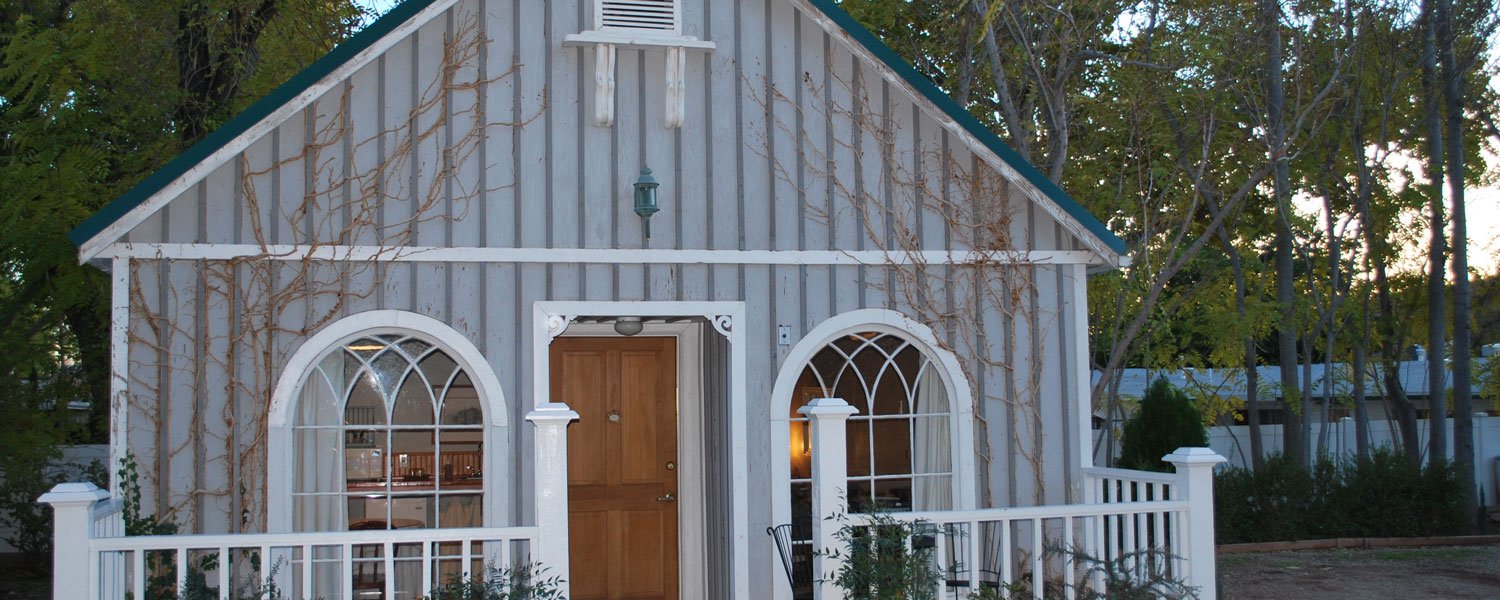 The private cottage on the inn's grounds, with arched windows and a white picket rail